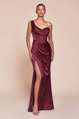 fitted gown showcases a one-shoulder pleated neckline with a gathered waistline and a leg slit