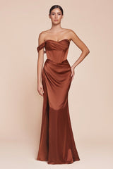 fitted gown showcases a one-shoulder pleated neckline with a gathered waistline and a leg slit