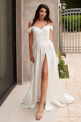 A simple sweetheart neckline gathers around the waistline, flowing into a light slitted skirt.