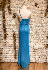 Mannequin wearing a turquoise sequin maxi dress with a one shoulder cutout, displayed against a floral backdrop.