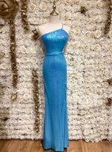 Mannequin wearing a turquoise sequin maxi dress with a one shoulder cutout, displayed against a floral backdrop.