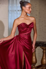 evening gown with a thigh-high slit and dramatic draped side sash