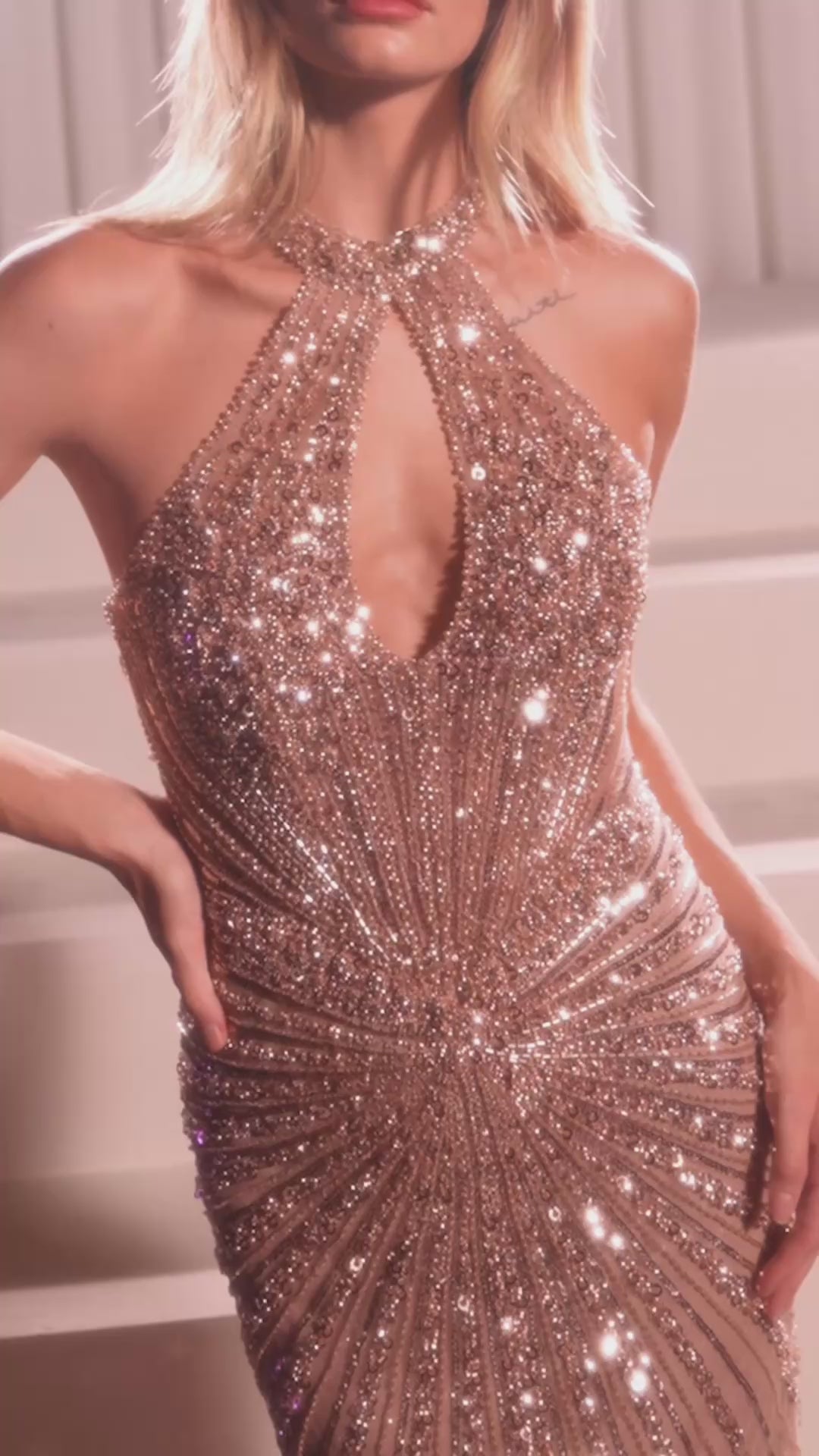 fitted gown featuring a chic halter keyhole neckline and a striking racerback design