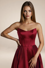 A-line gown features a structured strapless bodice with visible corset seaming and a lace-up back for adjustable support.