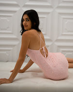 Pearl embellished mini dress with cowl neck and adjustable criss cross open back
