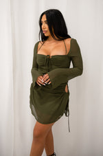 Mini dress with adjustable side cutouts, long mesh sleeves, adjustable front tie, halter neck and zipper back