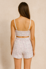 White tweed push up bustier paired with a matching tweed high waisted shorts.