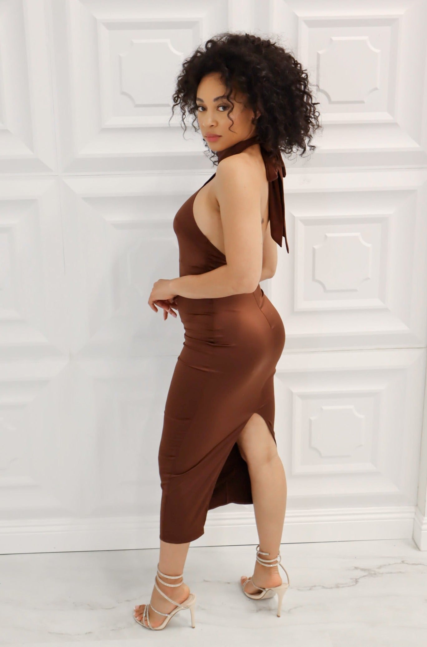 Satin bodycon midi dress with halter neck that ties, low back, and back slit in choclate