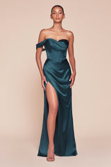  fitted gown showcases a one-shoulder pleated neckline with a gathered waistline and a leg slit