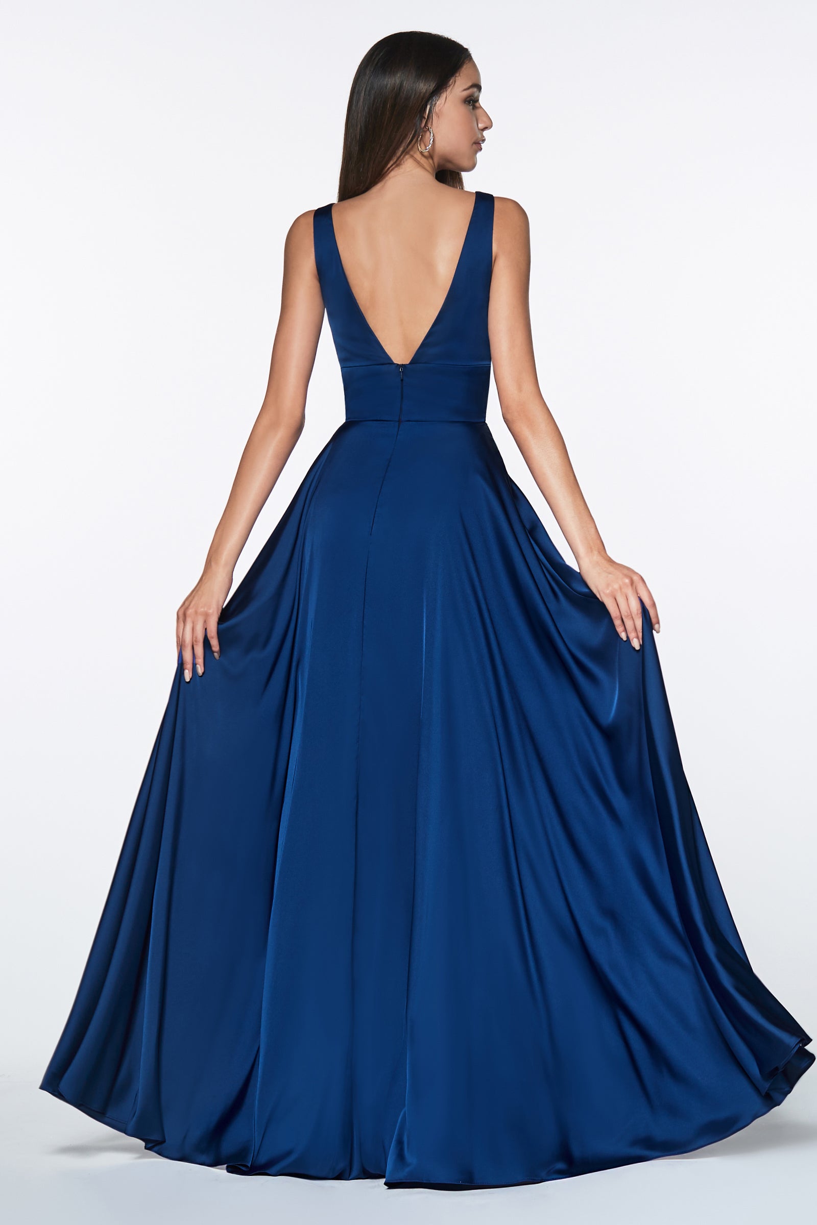 Woman wearing a blue evening gown with a plunging neckline on a white background