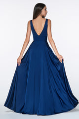Woman wearing a blue evening gown with a plunging neckline on a white background