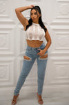 Mid rise skinny jeans with cutout rhinestone eye on the thighs
