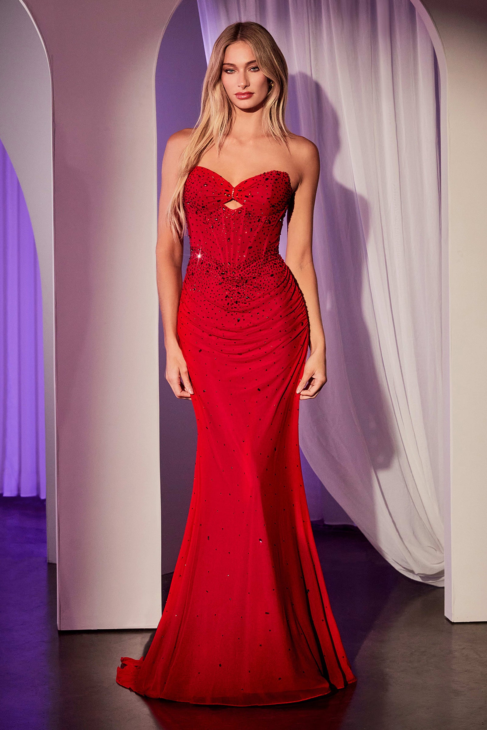 This fitted dress features a striking strapless keyhole neckline, accented with scattered rhinestone details for a touch of sparkle