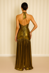 Metallic gold halter maxi dress with a front keyhole cutout, ruched detailing down the bodice, open tie-back, and a floor-length draped hem.