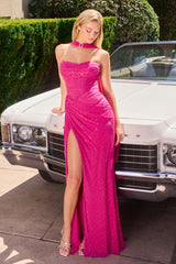 Model wearing a fitted gown featuring a draped bodice with sheer overlay, high side slit, and matching scarf accessory