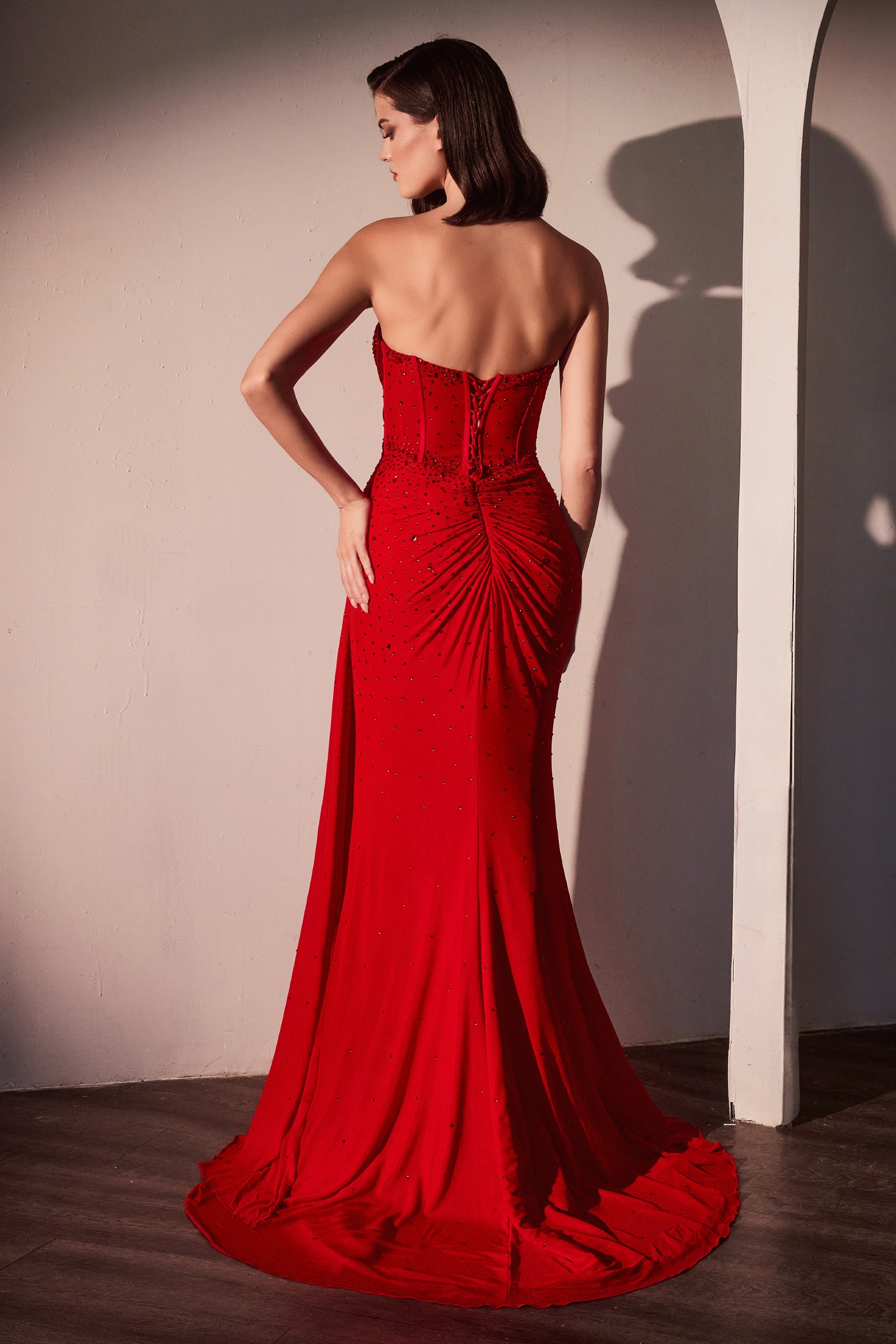  fitted strapless gown showcases a sweetheart neckline and a sheer bodice adorned with scattered rhinestone details  