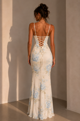 Blue floral corset maxi dress with spaghetti straps, lace-up back, draped hip detail, and a thigh-high slit.