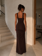 Ruched halter bodycon maxi dress with a ring-detail neckline and floor-length silhouette.