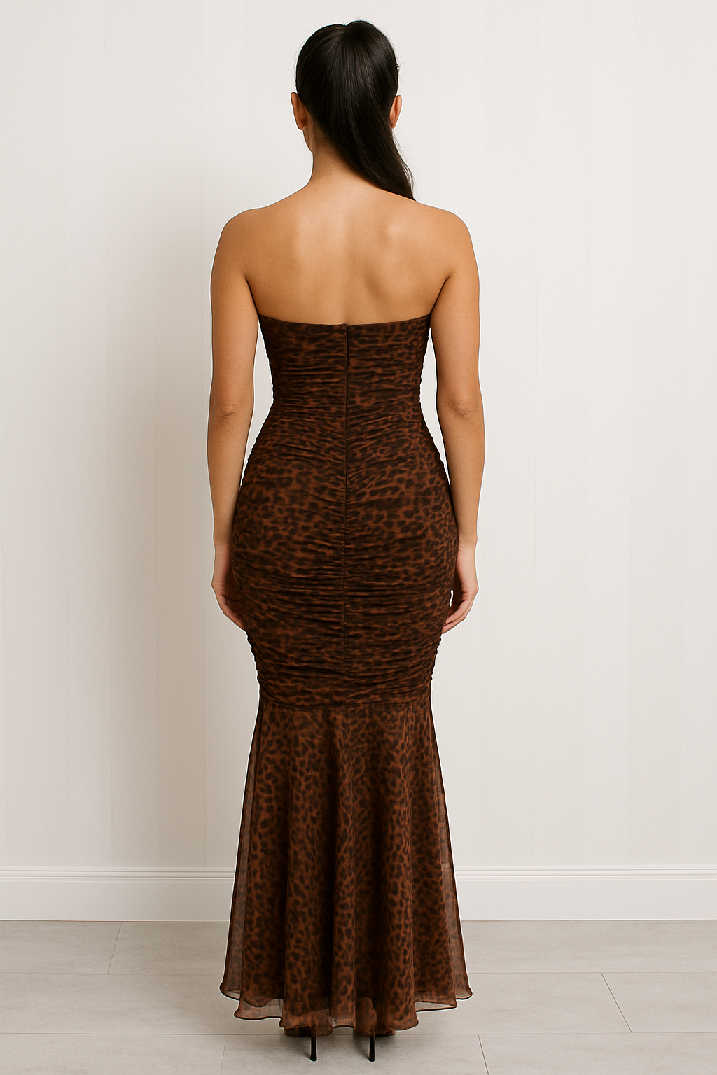 Strapless maxi dress with a sweetheart neckline, ruched bodice, bodycon fit through the hips, and flared sheer hemline in an animal print pattern.