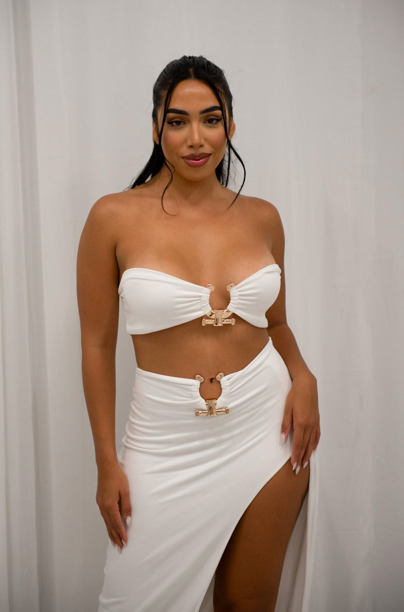 Strapless bandeu with gold metal detail and matching high slit maxi skirt