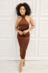 Satin bodycon midi dress with halter neck that ties, low back, and back slit in chocolate