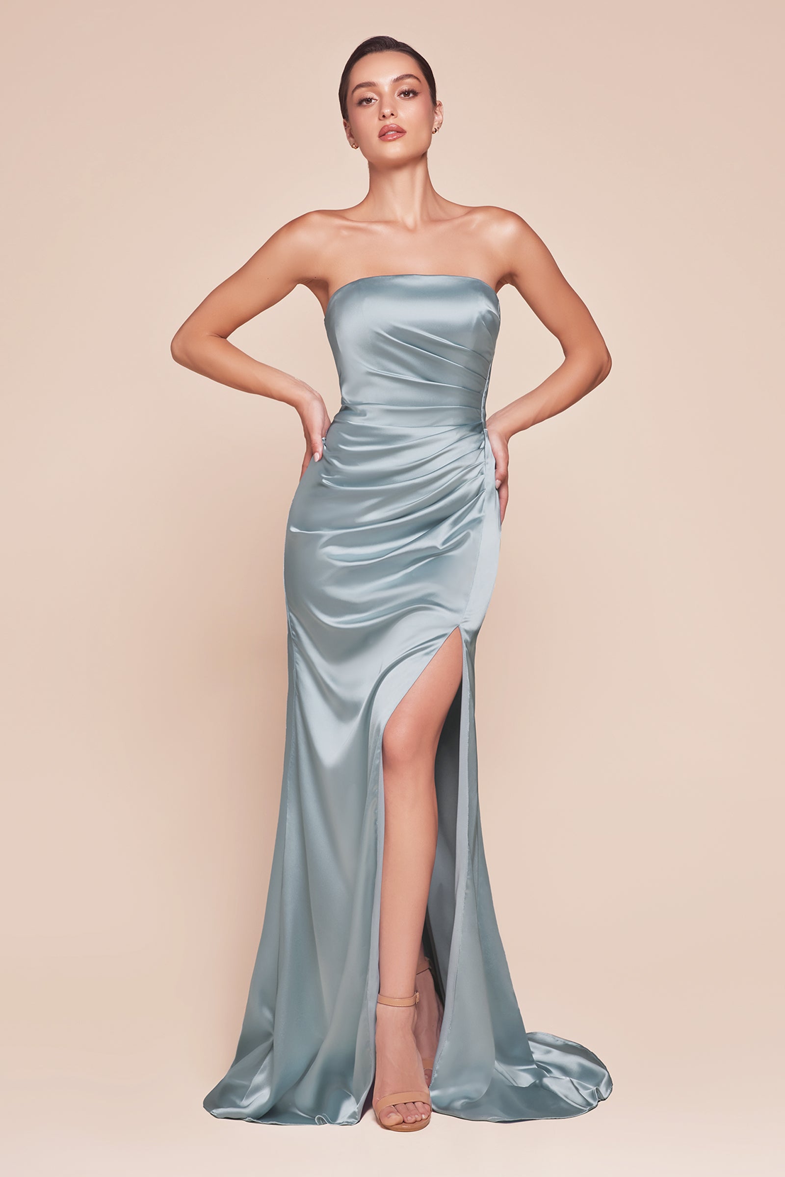 fitted strapless gown, crafted from luxe satin, features a sleek straight neckline, gathered waistline, and elegant leg slit.