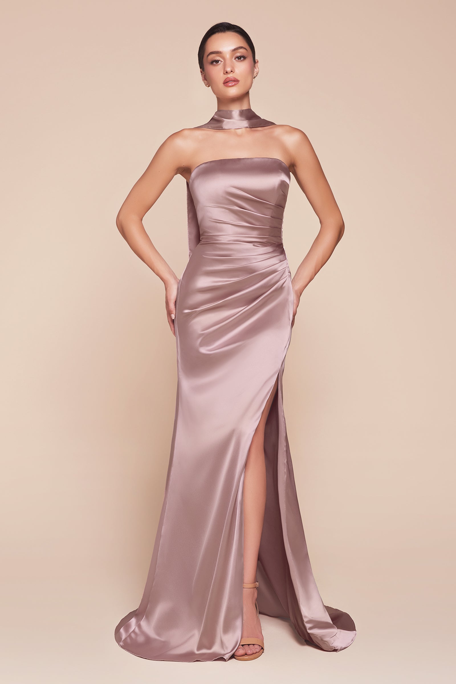 fitted strapless gown, crafted from luxe satin, features a sleek straight neckline, gathered waistline, and elegant leg slit