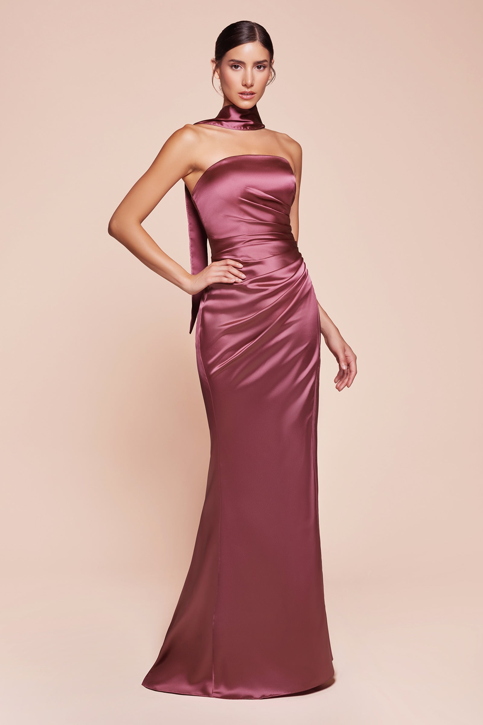 fitted strapless gown, crafted from luxe satin, features a sleek straight neckline, gathered waistline, and elegant leg slit