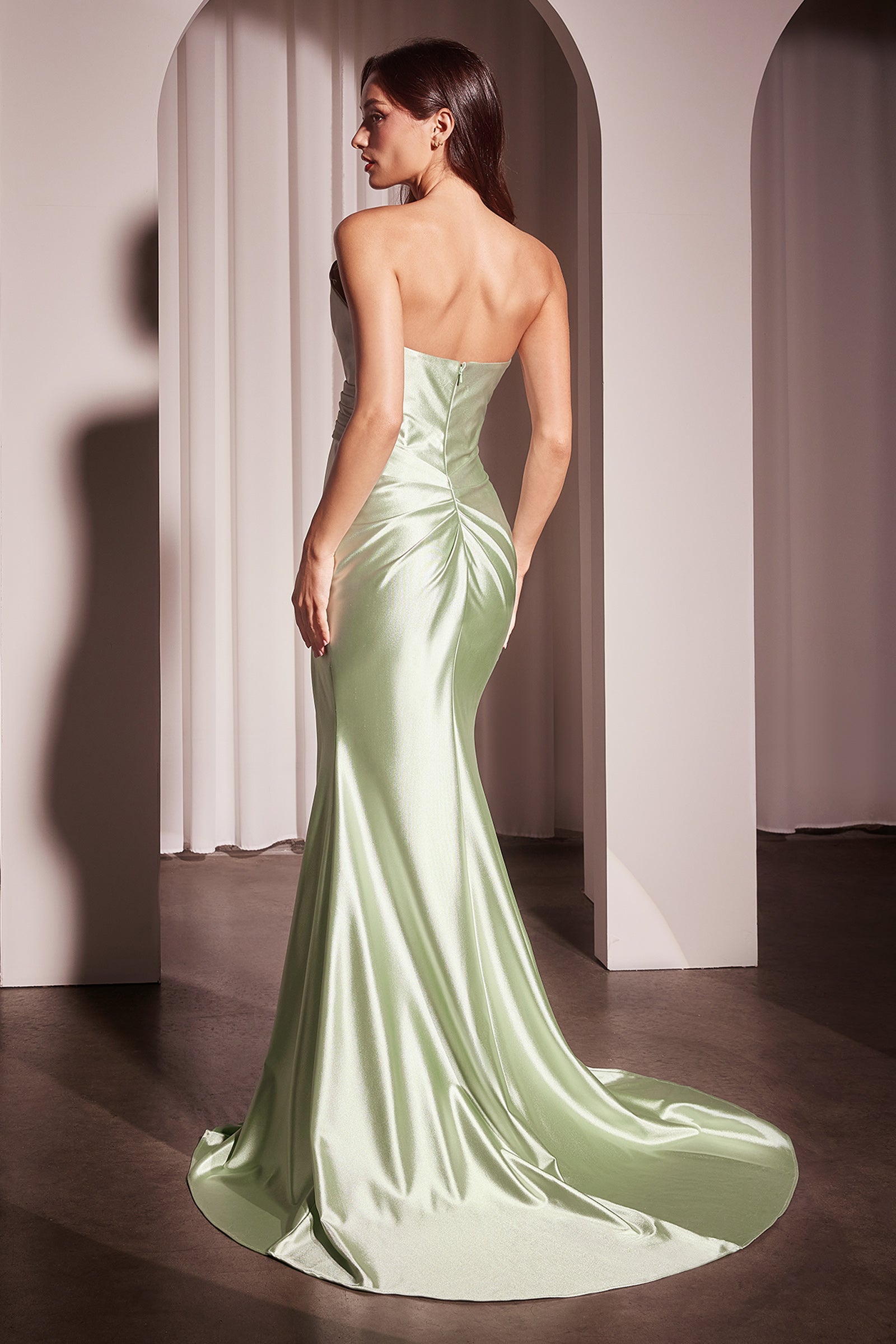 fitted satin dress, showcasing an asymmetrical strapless neckline and a beautifully pleated bodice