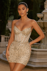 Woman wearing a sparkly gold dress in an outdoor setting