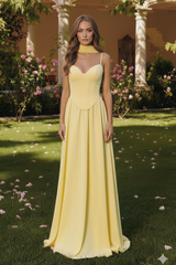 woman standing outdoors in a yellow dress