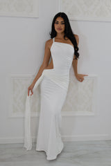 Model wearing a white one-shoulder maxi dress featuring a side waist cutout, front tie draping, and floor-length hem