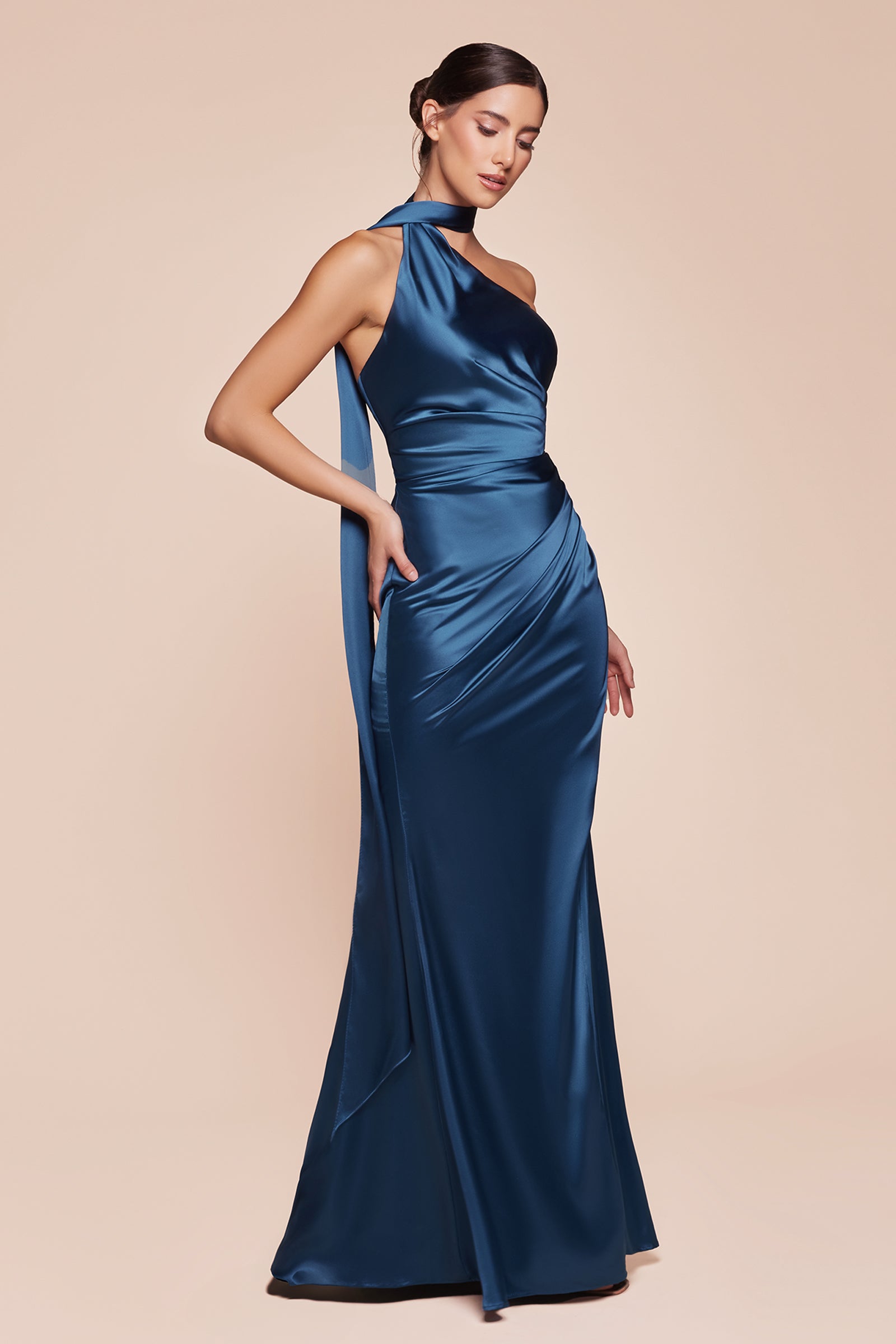 This fitted gown showcases a chic one-shoulder wrap halter neckline, with a gathered waistline and elegant leg slit for added allure