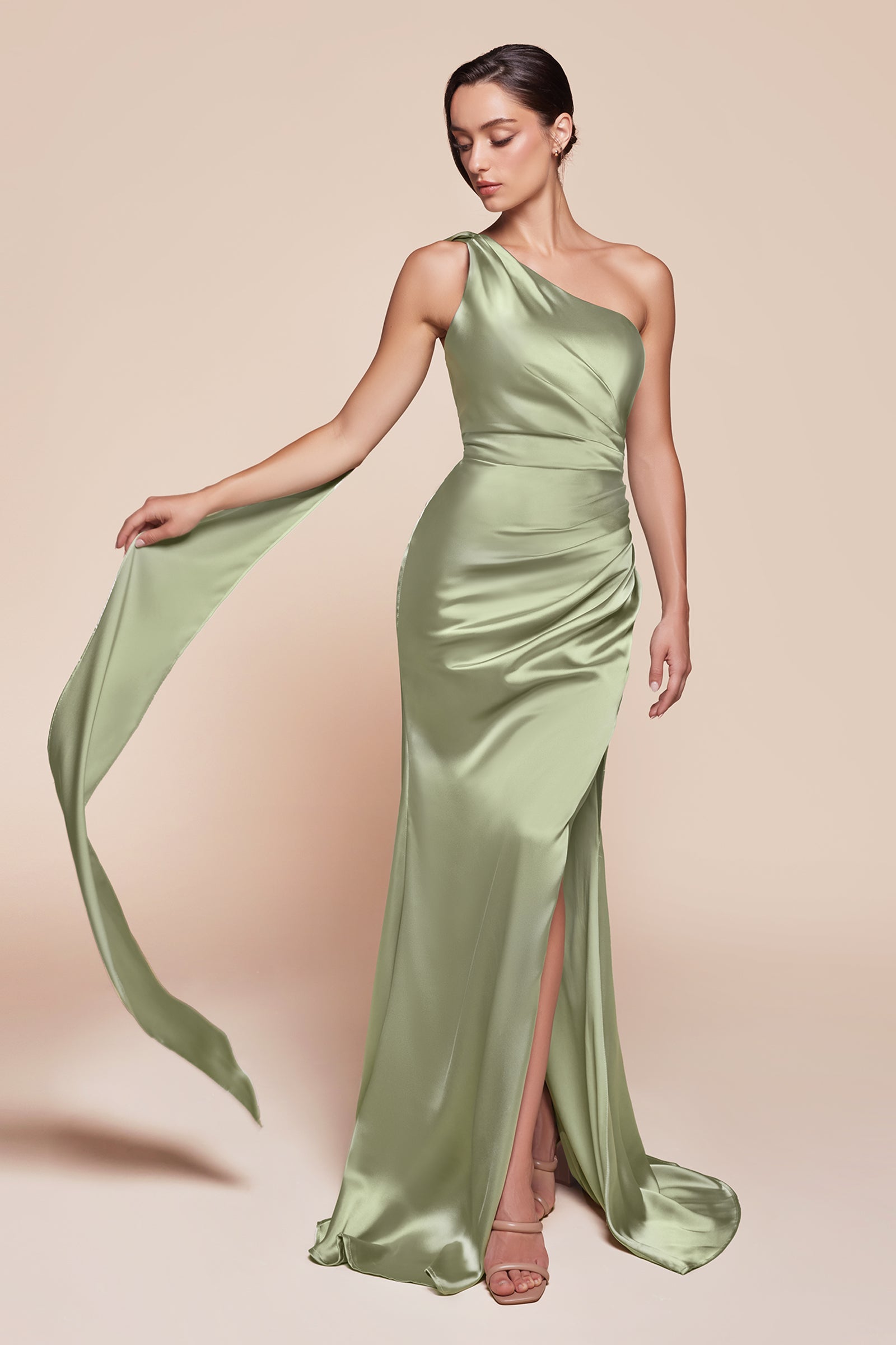 This fitted gown showcases a chic one-shoulder wrap halter neckline, with a gathered waistline and elegant leg slit for added allure