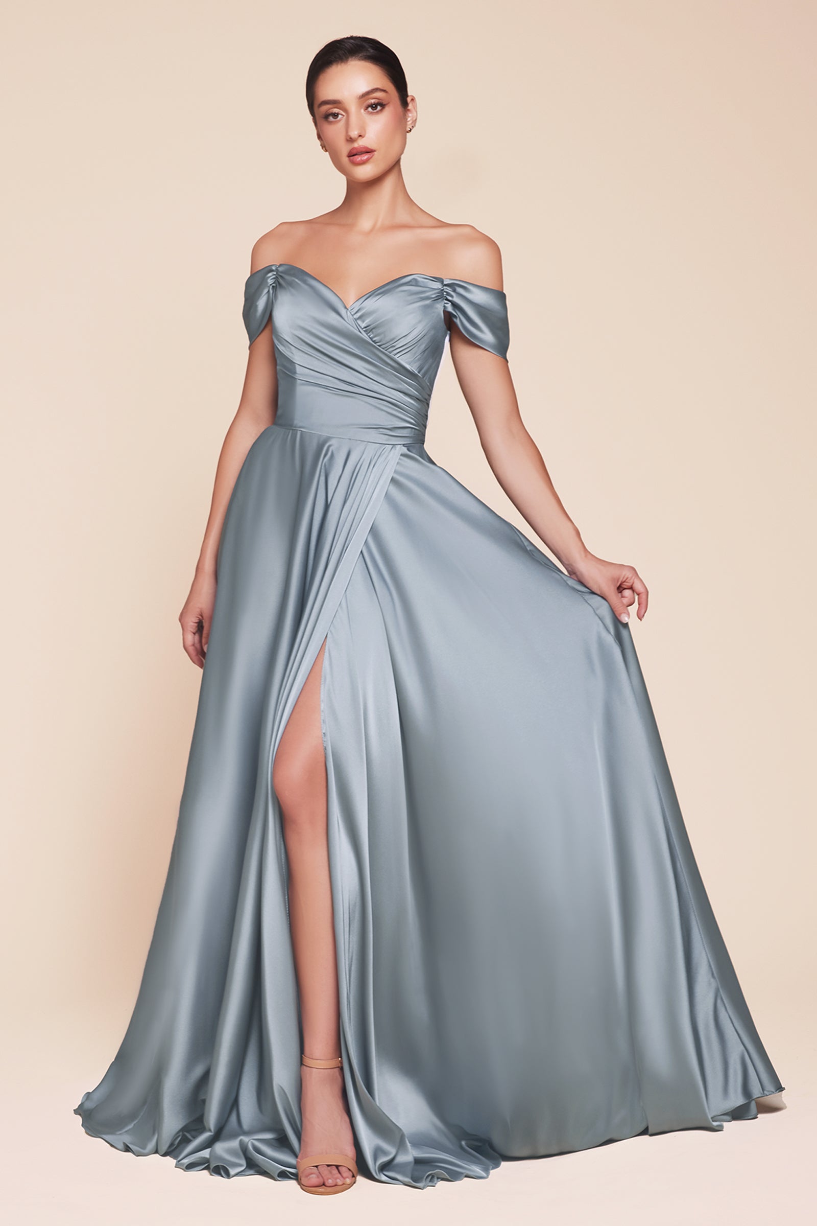 A simple sweetheart neckline gathers around the waistline, flowing into a light slitted skirt