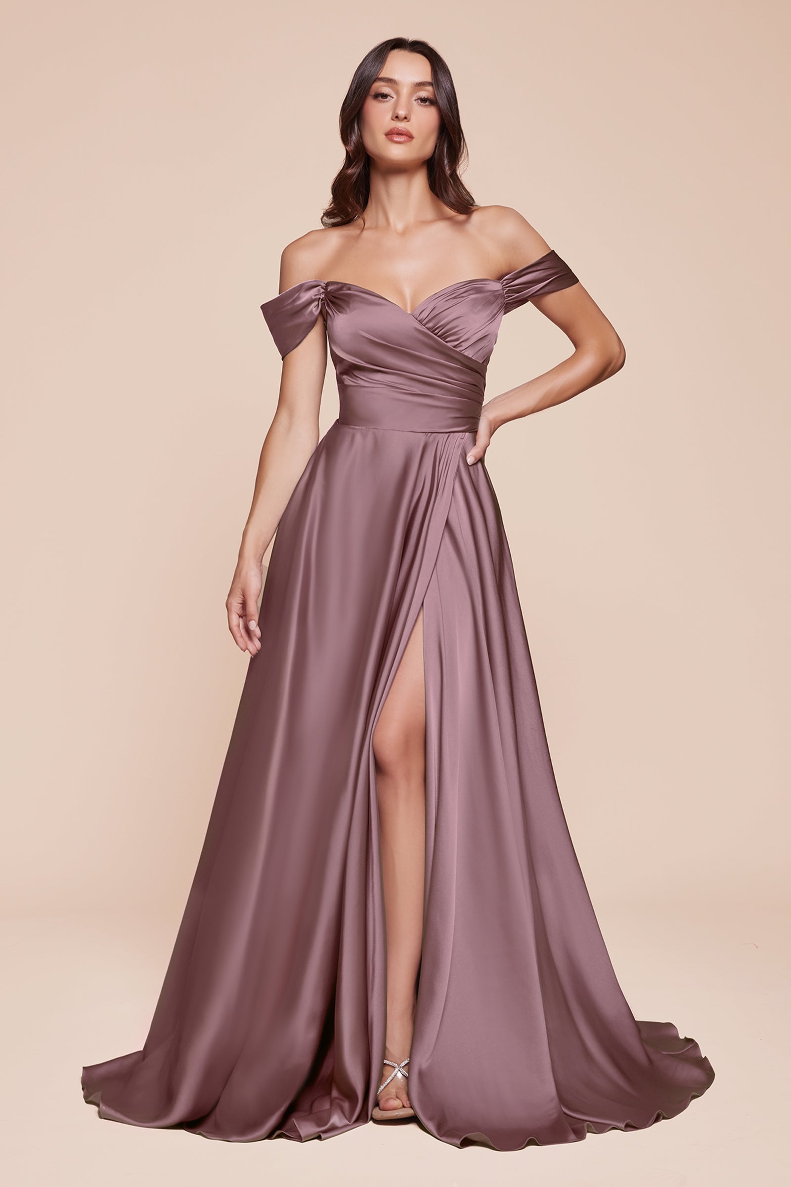 A simple sweetheart neckline gathers around the waistline, flowing into a light slitted skirt