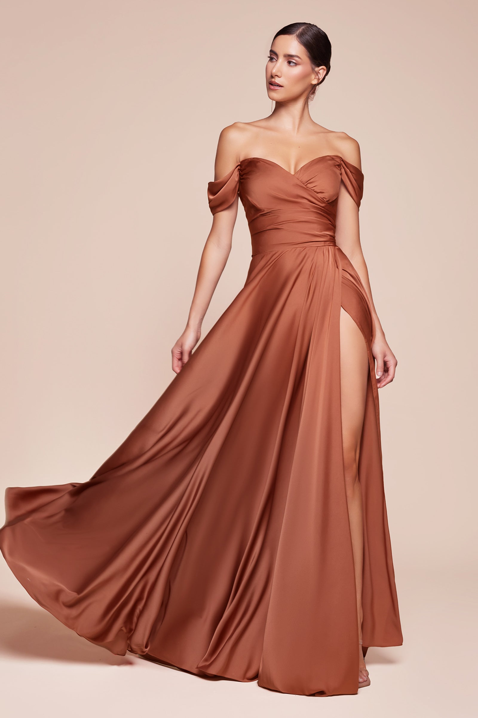 A simple sweetheart neckline gathers around the waistline, flowing into a light slitted skirt