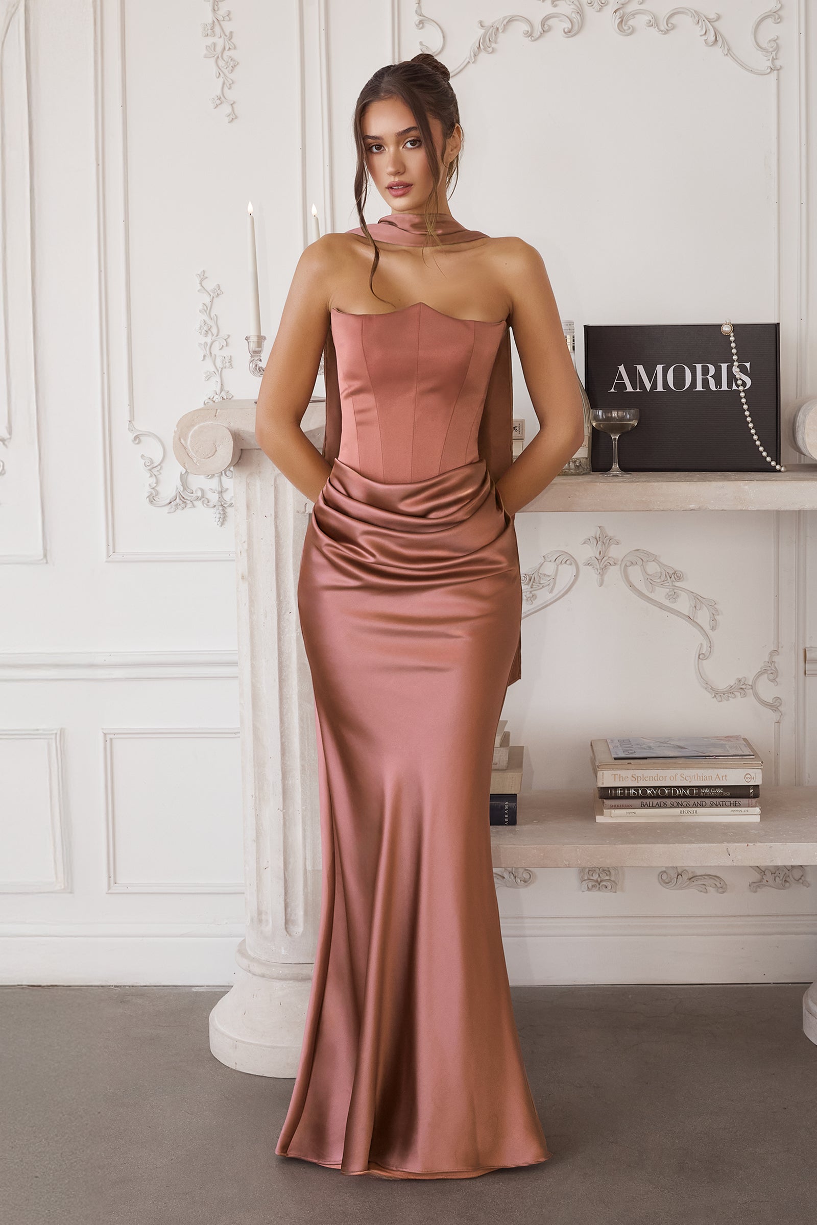 Woman wearing a pink strapless gown in an elegant room.