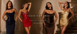 Four women modeling elegant evening gowns in a warm indoor setting. The dresses include a dark navy strapless gown, a red lace mini dress, a dark brown draped gown, and a metallic gold mini dress.