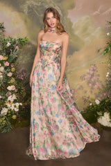 Woman wearing a floral strapless gown against a floral backdrop