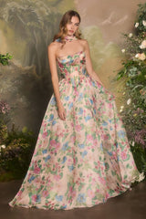 Woman wearing a floral strapless gown in a garden setting