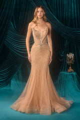 Woman in a beige evening gown standing in front of a draped curtain with teal accents.