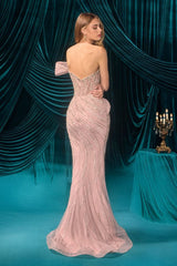Woman in a pink evening gown standing in front of blue velvet curtains.