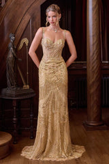 A woman models a floor-length gold evening gown with intricate beadwork and sequin embellishments in an ornate, dark wood-paneled room.