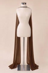 A brown sheer draped cape or shawl displayed on a cream-colored mannequin torso with a silver stand, set against a solid beige background.