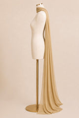 A draped beige scarf or shawl displayed on a cream mannequin torso with a gold stand against a plain beige studio background.