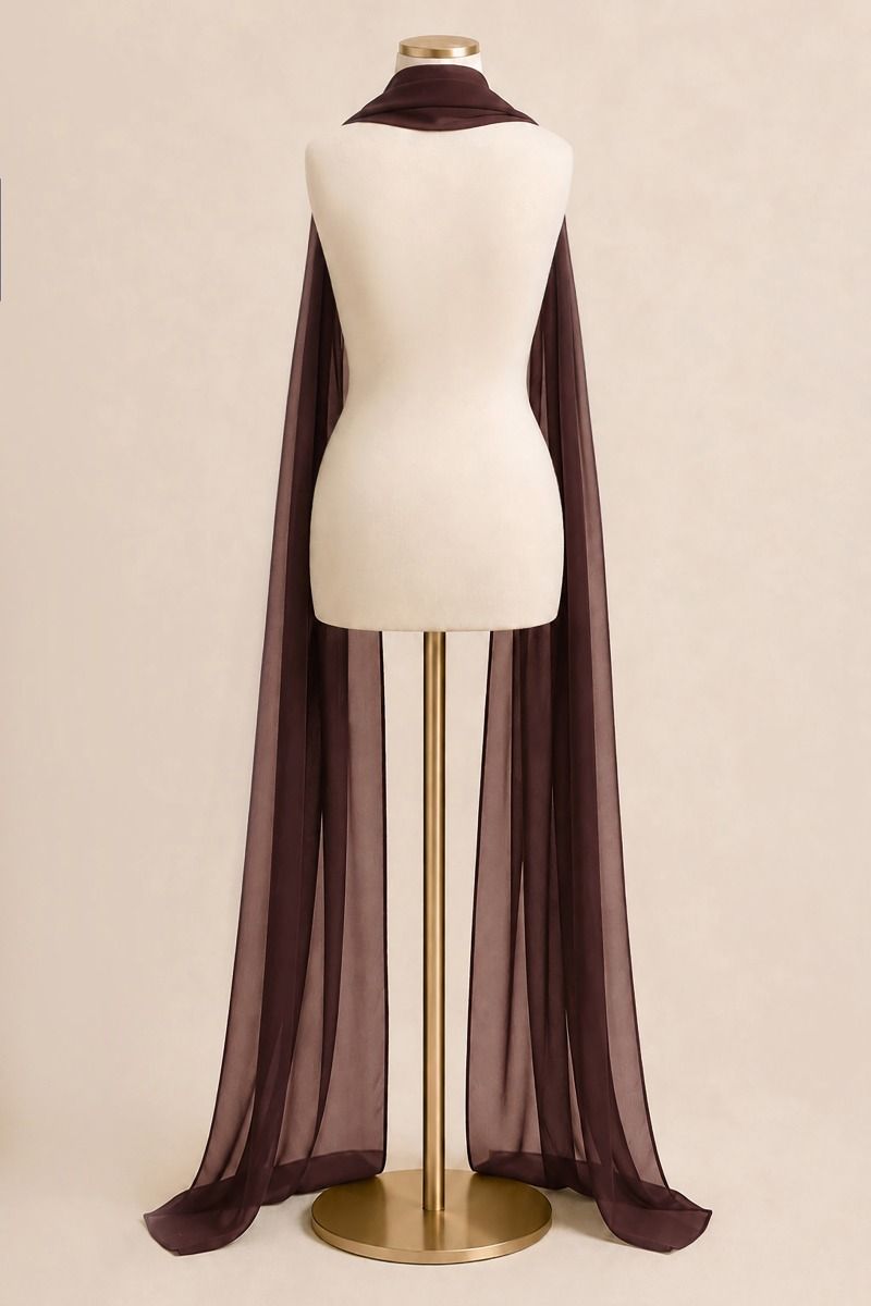 A long sheer dark brown cape-style drape or shawl displayed on a cream mannequin torso with a gold stand against a plain beige studio background.