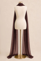 A long sheer dark brown cape-style drape or shawl displayed on a cream mannequin torso with a gold stand against a plain beige studio background.
