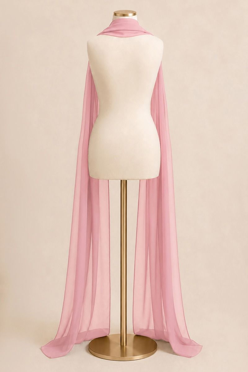A light pink sheer chiffon cape draped over a cream-colored mannequin torso on a gold stand, set against a solid beige background.