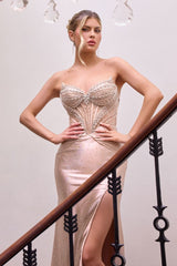 fitted gown showcases a sheer corset bodice embellished with intricate beadwork and rhinestone detailing